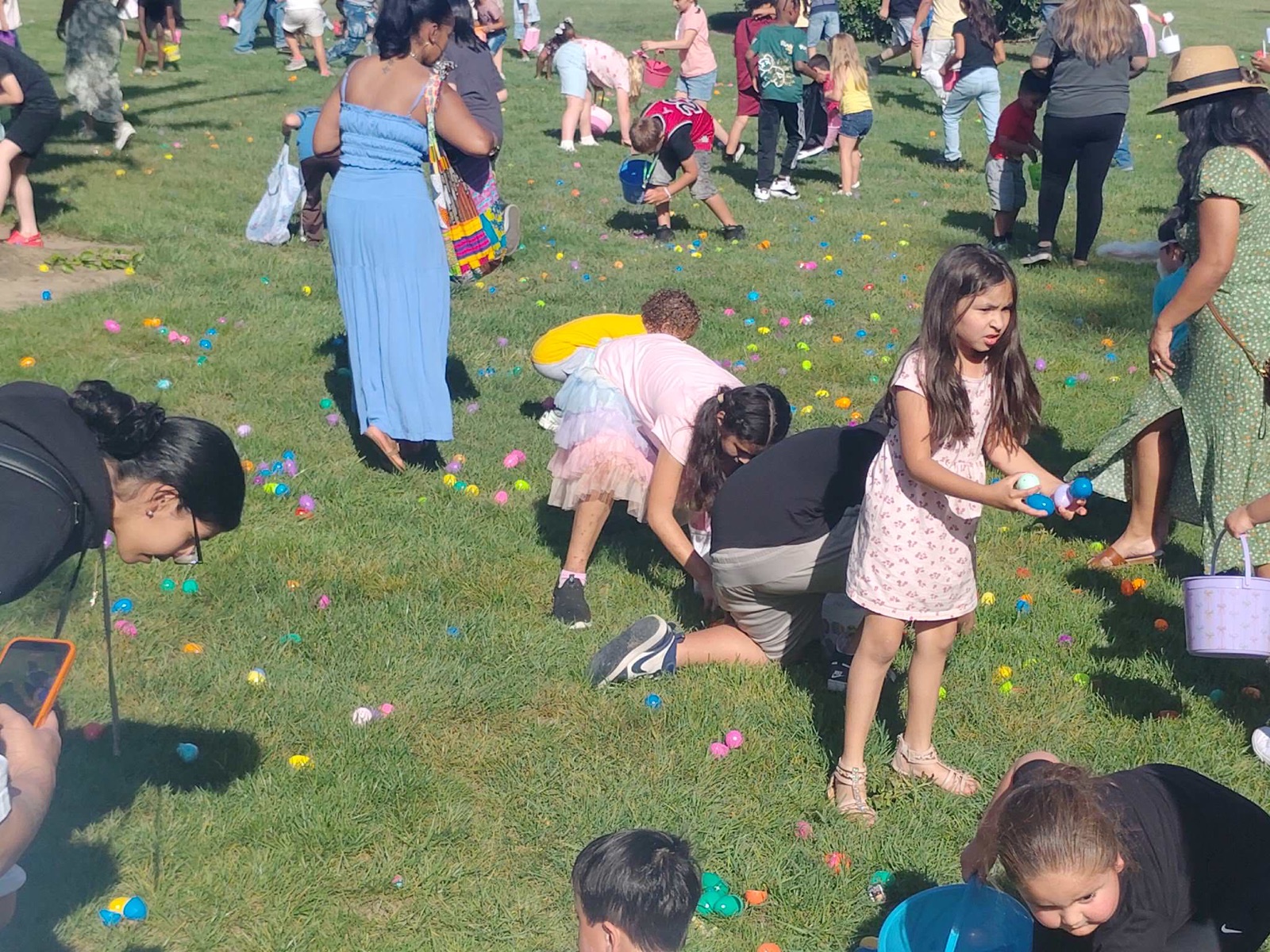Crowd of families on the lawn during the Easter egg hunt